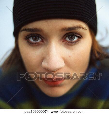 Young woman looking into camera, close-up, portrait View Large Photo Image Picture - Young woman looking into camera, close-up, portrait. Fotosearch