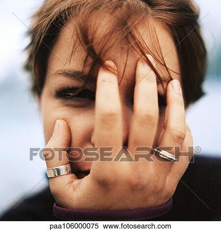 Young woman with hand over face, portrait View Large Photo Image Stock Photography - Young woman with hand over face, portrait. Fotosearch