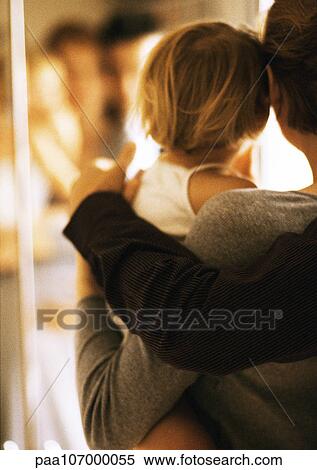 Stock Photography - Arms holding child, rear view, blurred. Fotosearch