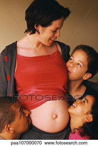 Man and children around pregnant woman's exposed stomach View Large Photo Image Stock Image - Man and children around pregnant woman's exposed stomach. Fotosearch