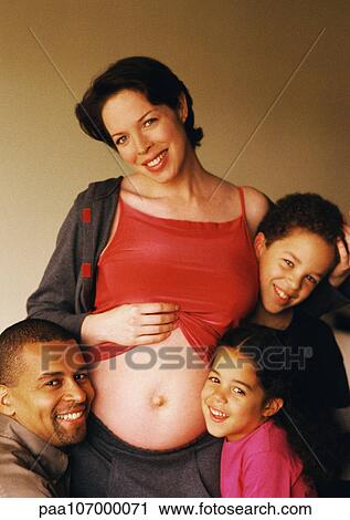 Man and children around pregnant woman's exposed stomach View Large Photo Image Stock Image - Man and children around pregnant woman's exposed stomach. Fotosearch