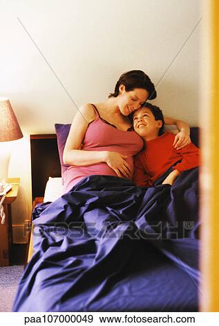 Pregnant woman and child in bed View Large Photo Image Stock Photo - Pregnant woman and child in bed. Fotosearch