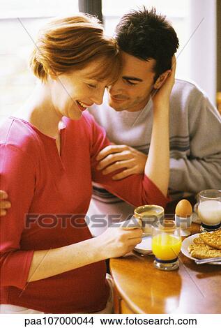 Pregnant woman and man having breakfast, smiling View Large Photo Image Picture - Pregnant woman and man having breakfast, smiling. Fotosearch