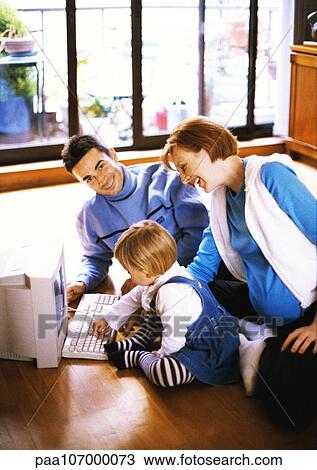 Pregnant woman and man on floor with child touching computer keyboard View Large Photo Image Stock Image - Pregnant woman and man on floor with child touching computer keyboard. Fotosearch