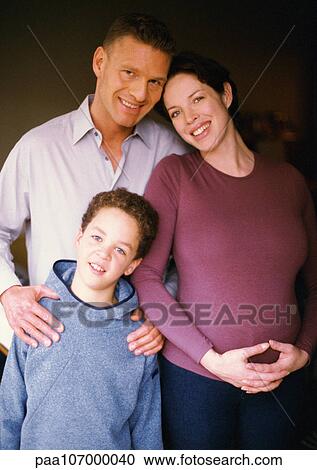 Pregnant woman and man standing with child, smiling, portrait View Large Photo Image Stock Image - Pregnant woman and man standing with child, smiling, portrait. Fotosearch