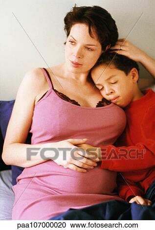 Pregnant woman sitting with child View Large Photo Image Stock Image - Pregnant woman sitting with child. Fotosearch