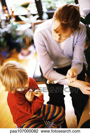 Woman feeding child View Large Photo Image Stock Image - Woman feeding child. Fotosearch