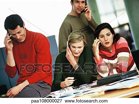 Stock Photo - Business people using cell phones. Fotosearch