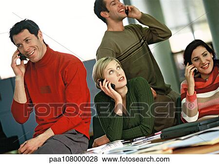 Business people using cell phones View Large Photo Image Stock Photo - Business people using cell phones. Fotosearch