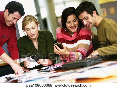 Stock Photo - Business people working at table. Fotosearch