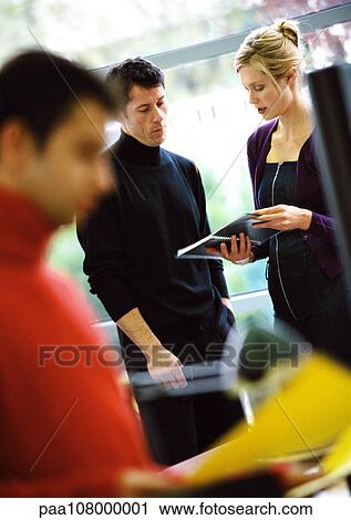 Stock Image - Business people working in office. Fotosearch