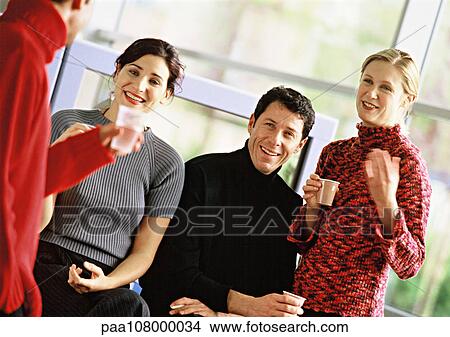 Four people holding plastic cups, portrait View Large Photo Image Picture - Four people holding plastic cups, portrait. Fotosearch