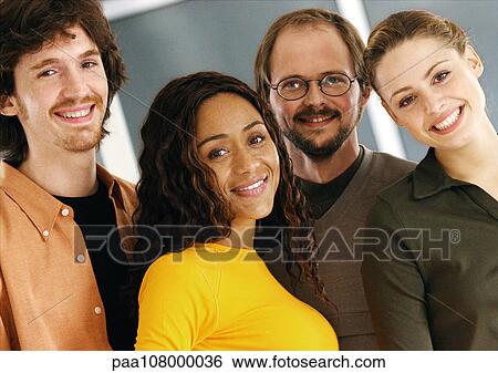 Stock Photograph - Four people smiling, portrait. Fotosearch