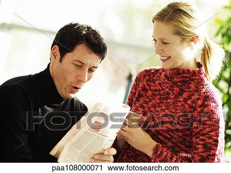 Man reading newspaper, woman holding plastic cup View Large Photo Image Stock Image - Man reading newspaper, woman holding plastic cup. Fotosearch