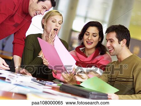 People examining documents, smiling View Large Photo Image Stock Photography - People examining documents, smiling. Fotosearch