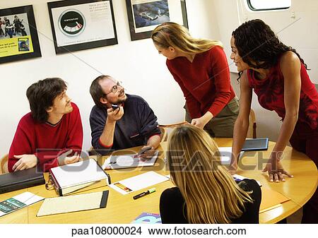People in conference room, gathered around table View Large Photo Image Picture - People in conference room, gathered around table. Fotosearch