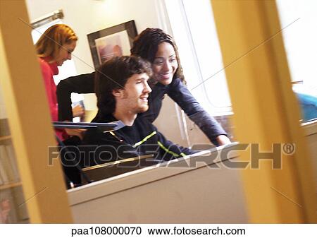 Stock Image - People in office, smiling. Fotosearch