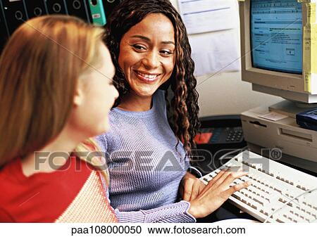Women working at computer, smiling View Large Photo Image Stock Image - Women working at computer, smiling. Fotosearch