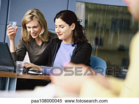 Women working on laptop computer View Large Photo Image Stock Photography - Women working on laptop computer. Fotosearch