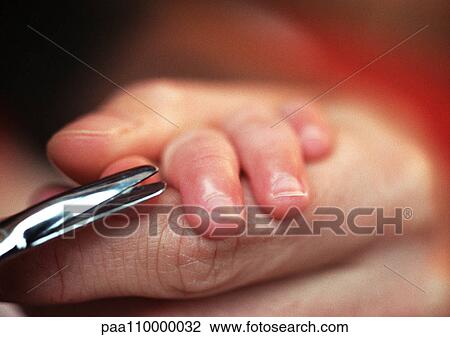 Adult cutting baby's nails, close-up View Large Photo Image Stock Image - Adult cutting baby's nails, close-up. Fotosearch