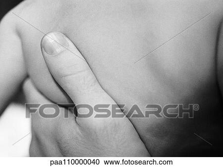 Stock Image - Adult's hand on baby's back, close-up, b&w. Fotosearch