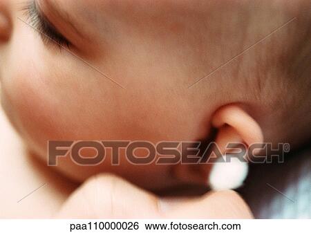 Baby having ear cleaned with cotton swab, close-up View Large Photo Image Stock Photograph - Baby having ear cleaned with cotton swab, close-up. Fotosearch