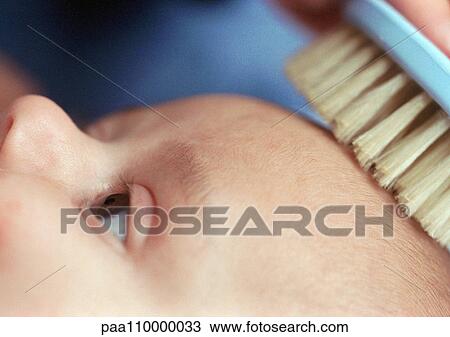 Baby having hair brushed, close-up of head and brush, partial view View Large Photo Image Stock Image - Baby having hair brushed, close-up of head and brush, partial view. Fotosearch