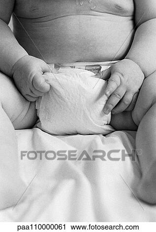 Baby sitting with hand's on diaper, mid-section, front view, close-up, b&w View Large Photo Image Stock Image - Baby sitting with hand's on diaper, mid-section, front view, close-up, b&w. Fotosearch