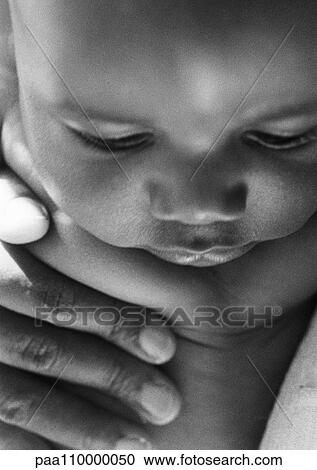 Baby with adult hand on chest, close-up, b&w View Large Photo Image Stock Image - Baby with adult hand on chest, close-up, b&w. Fotosearch