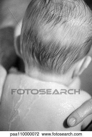 Stock Image - Baby with wet hair and back, rear view, close-up, b&w. Fotosearch