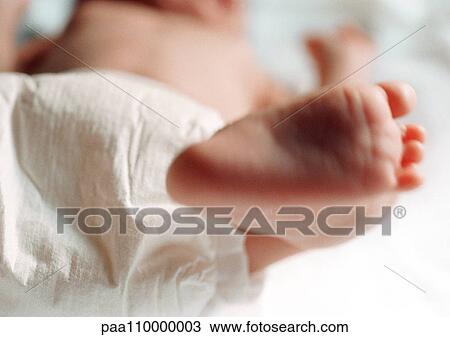 Stock Image - Baby's foot, close-up. Fotosearch