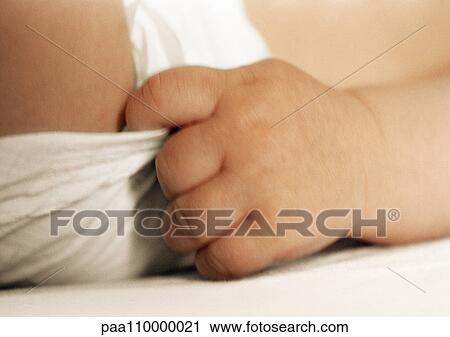 Baby's hand pulling on diaper, close-up View Large Photo Image Stock Image - Baby's hand pulling on diaper, close-up. Fotosearch