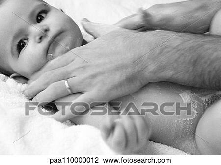 Man's hands rubbing in baby powder on baby's torso, close-up, b&w View Large Photo Image Stock Image - Man's hands rubbing in baby powder on baby's torso, close-up, b&w. Fotosearch