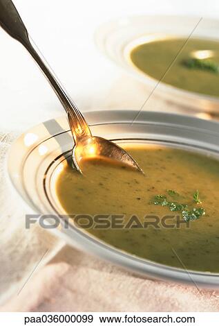 Bowls of green soup with herb garnish, close-up View Large Photo Image Stock Photo - Bowls of green soup with herb garnish, close-up. Fotosearch