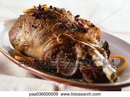 Leg of lamb with spices and zest on dish, close-up View Large Photo Image Stock Photo - Leg of lamb with spices and zest on dish, close-up. Fotosearch