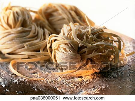 Mounds of fresh pasta on floured board, close-up View Large Photo Image Stock Image - Mounds of fresh pasta on floured board, close-up. Fotosearch