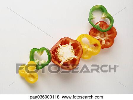 Stock Photo - Slices of red, yellow and green bell peppers. Fotosearch