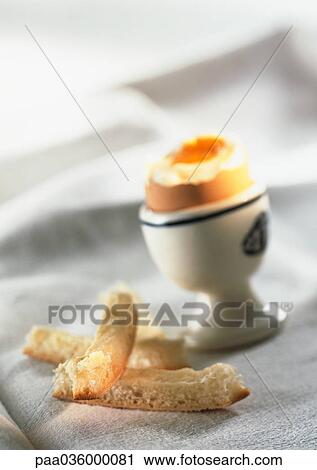 Soft-boiled egg in eggcup, blurred, with bread crusts View Large Photo Image Stock Image - Soft-boiled egg in eggcup, blurred, with bread crusts. Fotosearch