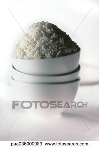Stack of three white bowls, mound of white rice in top bowl, close-up View Large Photo Image Stock Photo - Stack of three white bowls, mound of white rice in top bowl, close-up. Fotosearch
