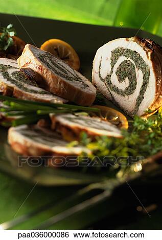 Stuffed turkey roll cut into slices, garnished with herbs and lemon slices, close-up View Large Photo Image Stock Photograph - Stuffed turkey roll cut into slices, garnished with herbs and lemon slices, close-up. Fotosearch
