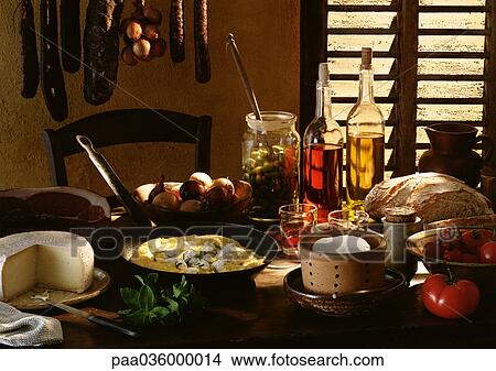 Table spread with various foods and cooking ingredients View Large Photo Image Picture - Table spread with various foods and cooking ingredients. Fotosearch