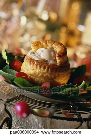 Vol-au-vent (french pastry with savory filling), on bed of greens, close-up View Large Photo Image Picture - Vol-au-vent (french pastry with savory filling), on bed of greens, close-up. Fotosearch