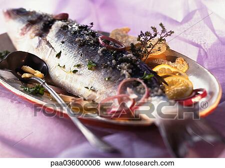 Whole cooked fish with citrus fruit and herbs on dish, close-up View Large Photo Image Stock Photograph - Whole cooked fish with citrus fruit and herbs on dish, close-up. Fotosearch
