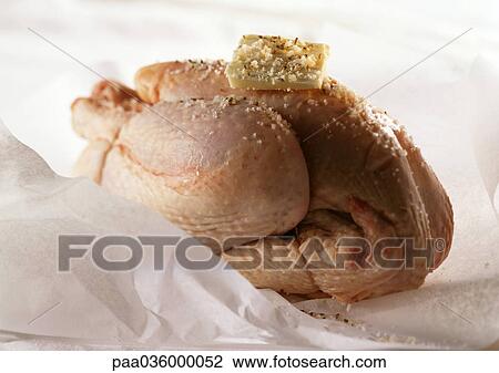 Whole raw chicken and with pat of butter on top, on cooking paper, close-up View Large Photo Image Stock Image - Whole raw chicken and with pat of butter on top, on cooking paper, close-up. Fotosearch