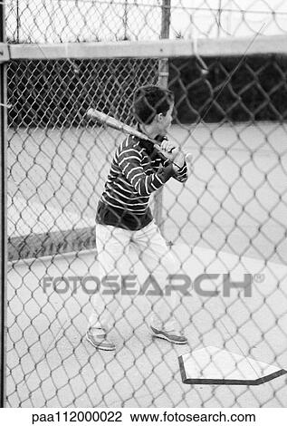Boy holding baseball bat, rear view, b&w View Large Photo Image Stock Image - Boy holding baseball bat, rear view, b&w. Fotosearch