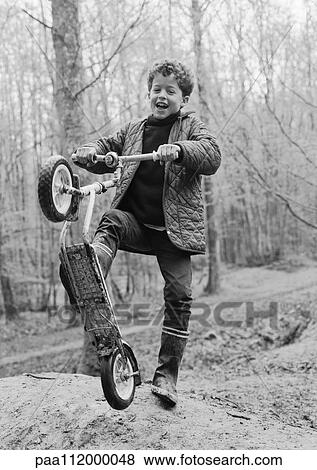 Boy holding scooter, b&w View Large Photo Image Stock Photo - Boy holding scooter, b&w. Fotosearch