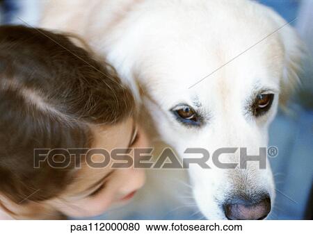Stock Image - Girl and dog side by side, elevated view. Fotosearch