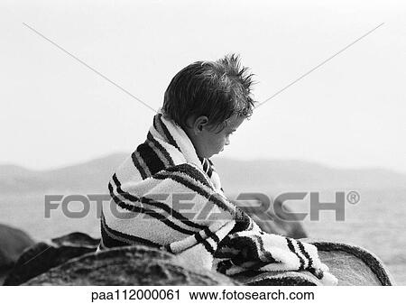 Stock Image - Girl in bath towel, sitting, b&w. Fotosearch