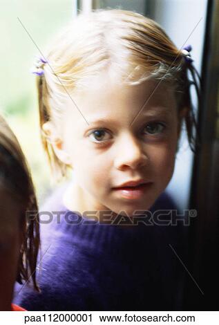 Stock Image - Girl looking into camera, portrait. Fotosearch