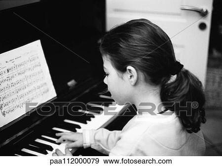 Girl playing piano, side view, b&w View Large Photo Image Stock Photo - Girl playing piano, side view, b&w. Fotosearch